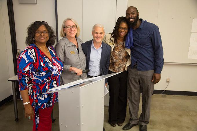 Photograph of neighborhood organization leaders and educators smiling.